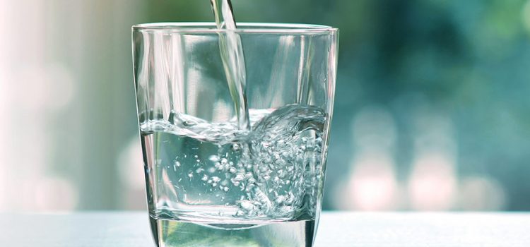 A glass of water treated by a water softener in Austin Texas