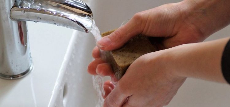 Washing hands at faucet