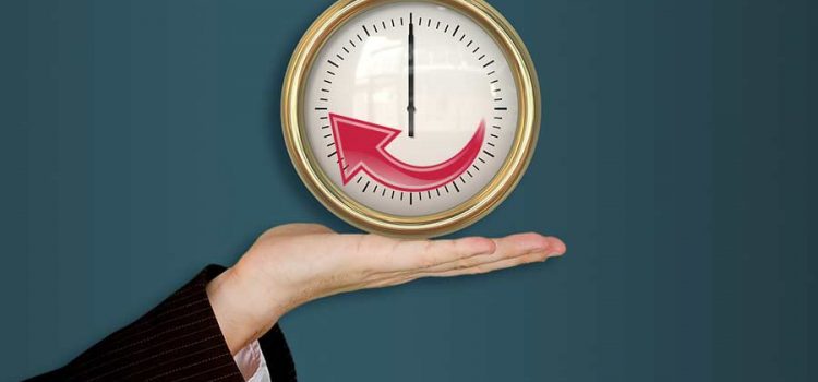 Hand holding a clock illustrating improved system life with maintenance from an Austin TX water softener company