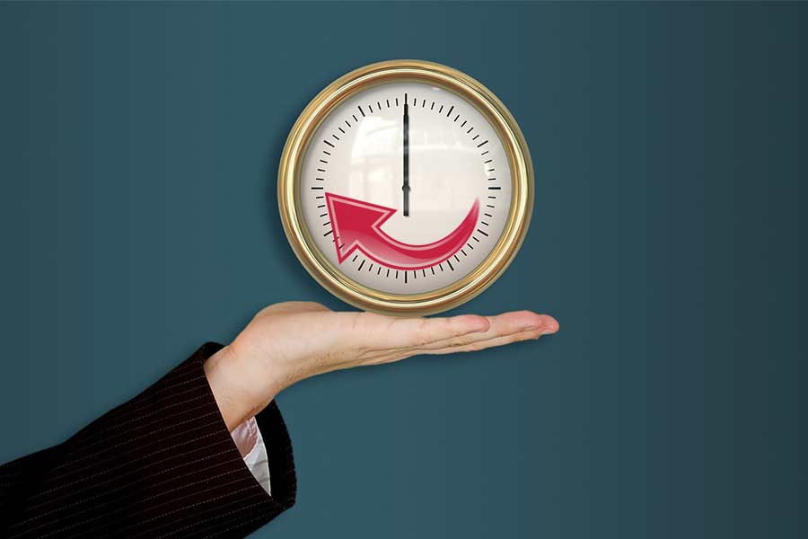 Hand holding a clock illustrating improved system life with maintenance from an Austin TX water softener company