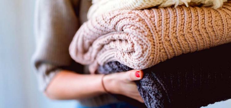 Woman holding a stack of laundry