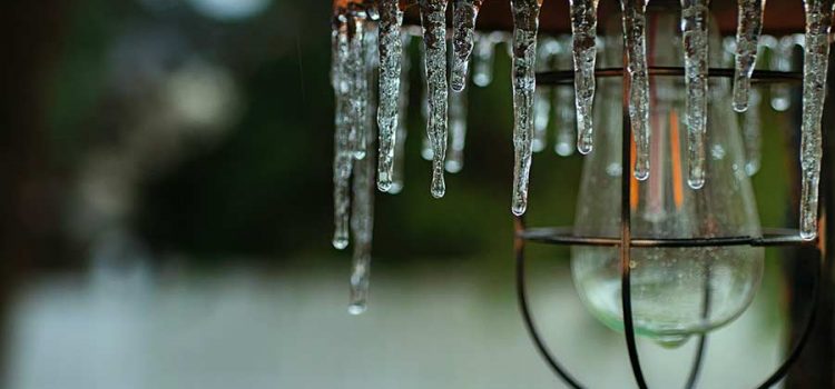 House porch light covered in icicles