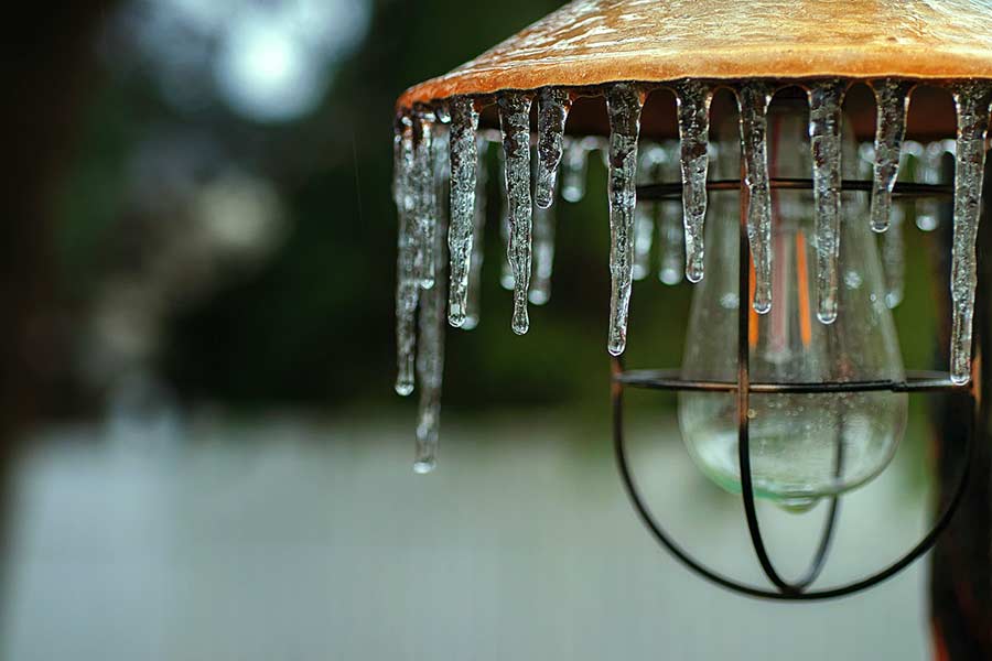 House porch light covered in icicles