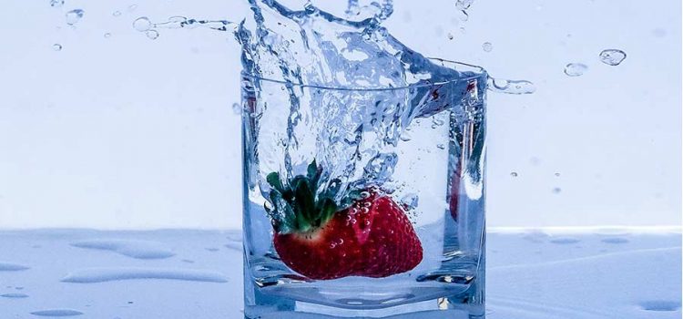 Glass of purified water with a strawberry