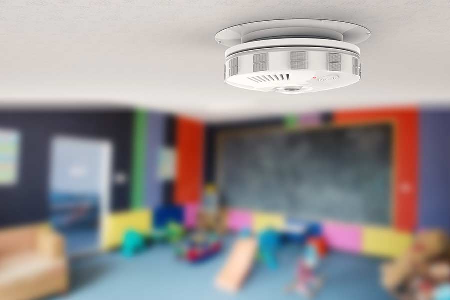 Carbon monoxide detector on the ceiling of a children's play room