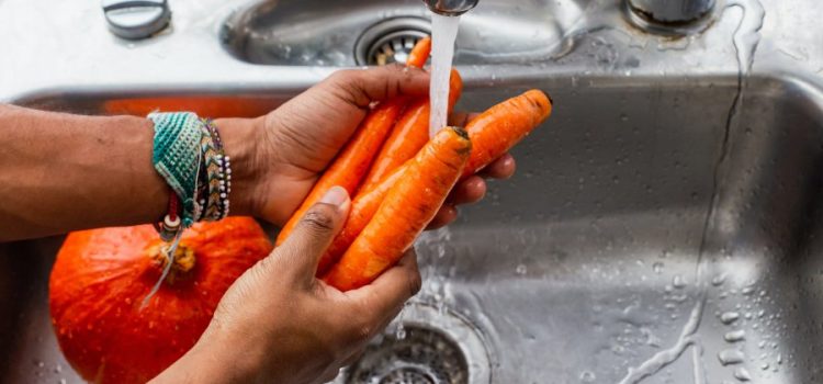 Person Washing Veggies with Water Softener in Liberty Hill