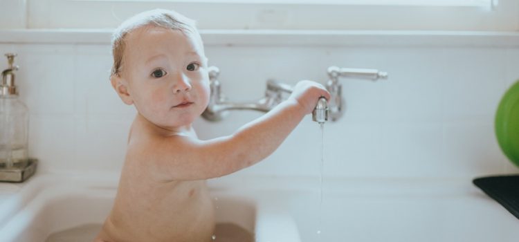 baby taking a bath thanks to water conditioner companies in Austin TX