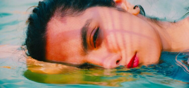 A woman relaxing in clean water thanks to her Austin TX water softener.