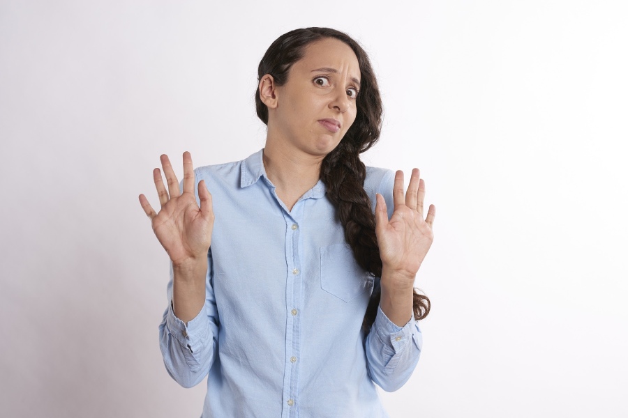 A woman experiencing an unpleasant sulfur smell emanating from the tap due to issues with quality from Austin water systems.