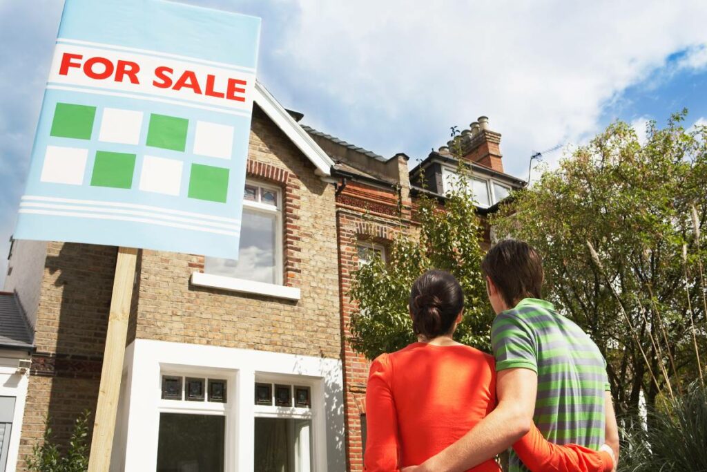 Couple looking at a two story house with a 