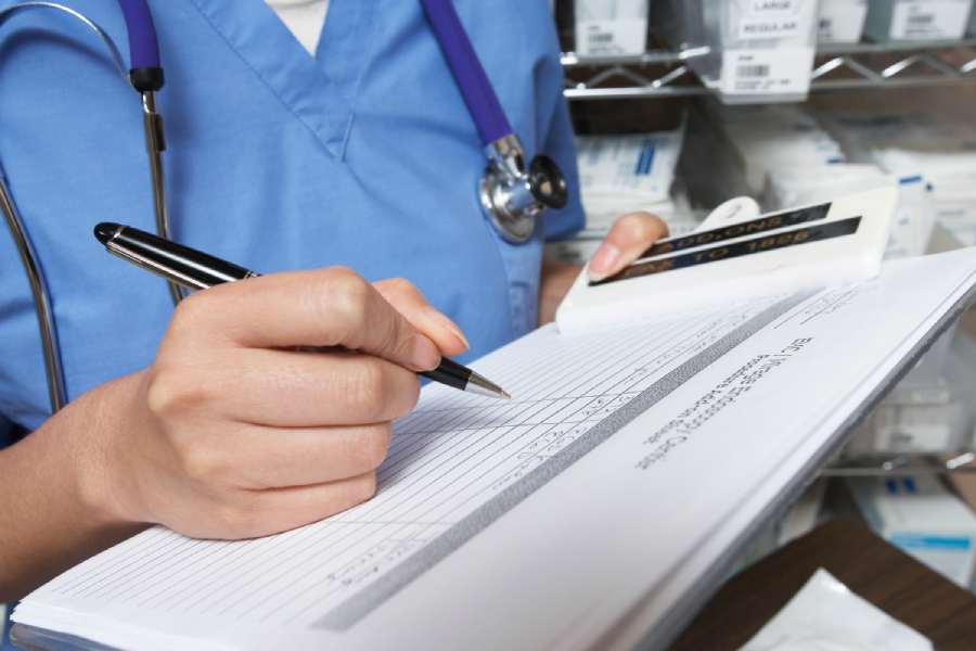 Doctor filling out information in a patient's chart