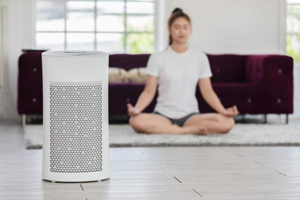 Woman meditating in a purified room thanks to Air purification in Austin.