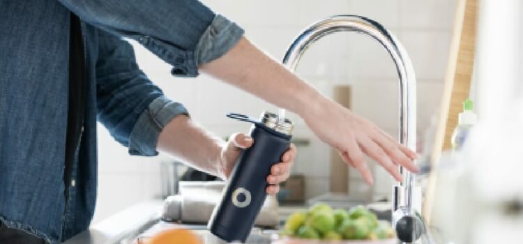 An image of a person enjoying fresh clear water with reverse Osmosis water filtration in Leander