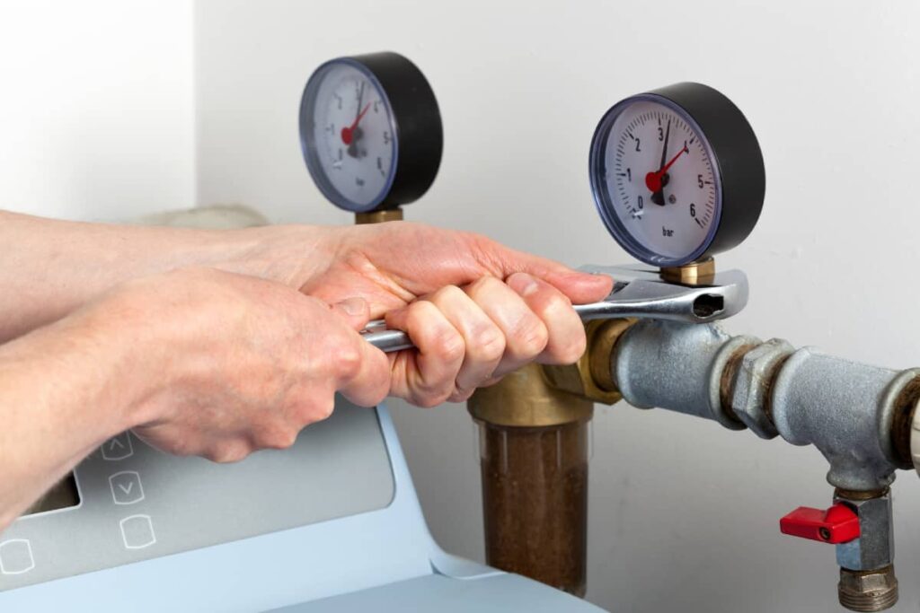 Experienced technician from Liberty Hill water softening companies performing maintenance on a water softener