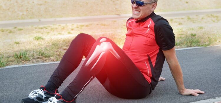 An image of a man grimacing in pain, clutching his knee due to dehydration highlighting the necessity of water filtration in Cedar Park.