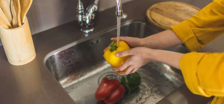 washing vegetables with clean water from the system of water conditioning in Bastrop