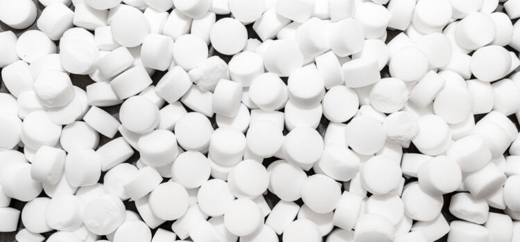 Close-up of water softener salt pellets used for the ion exchange regeneration process