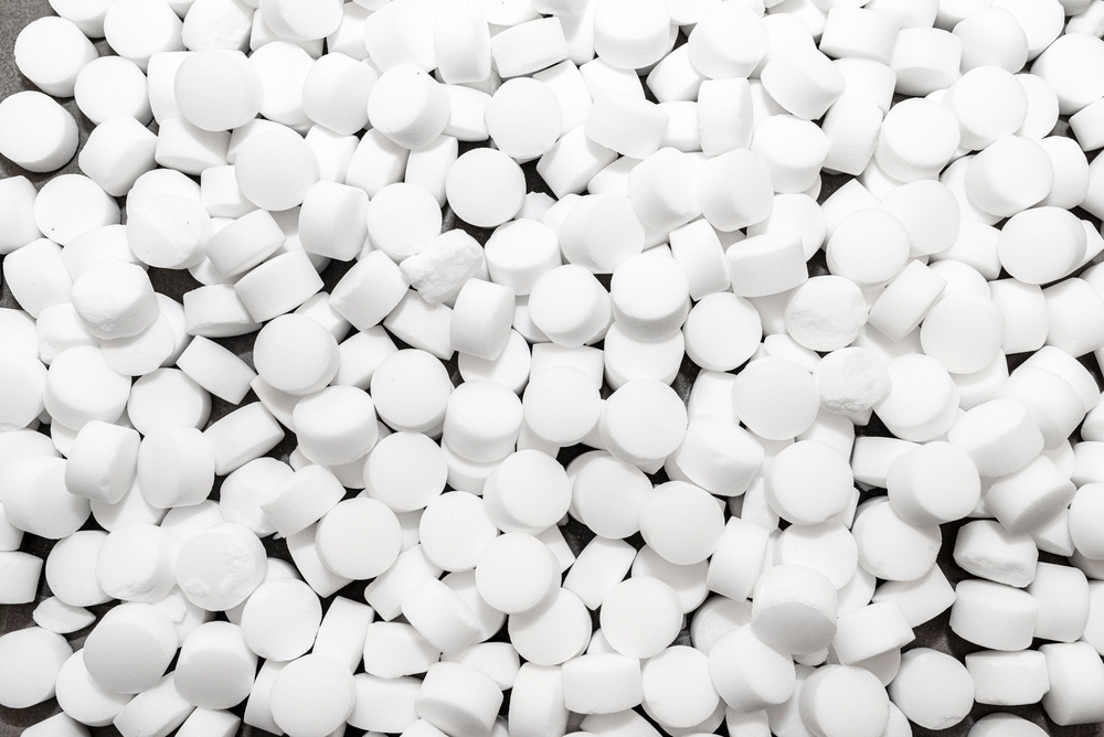 Close-up of water softener salt pellets used for the ion exchange regeneration process