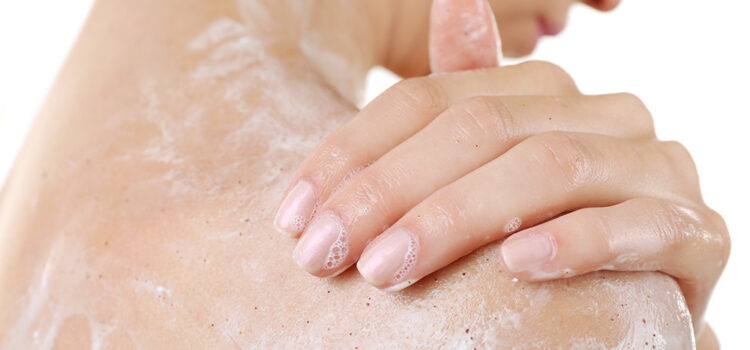 Woman covered in soap in the shower, showing effects of hard water and soap residue on skin in Texas
