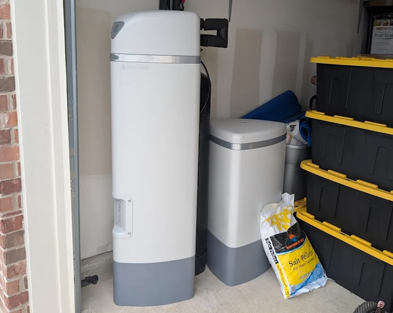 Water softener system in a Texas home garage providing clean, softened water for San Antonio, Austin, and Houston homeowners